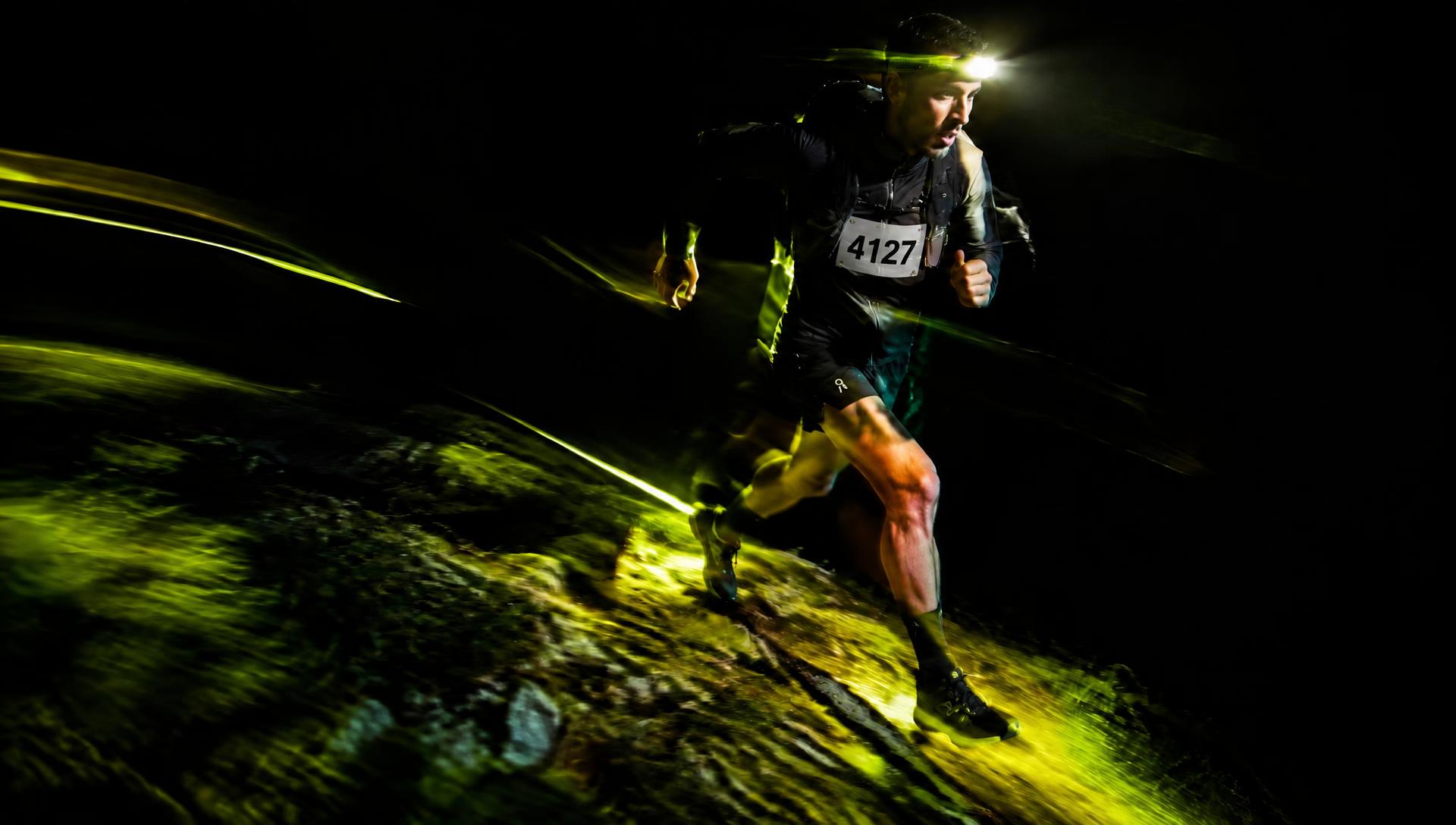 Night trail runner with headlamp and bib 4127